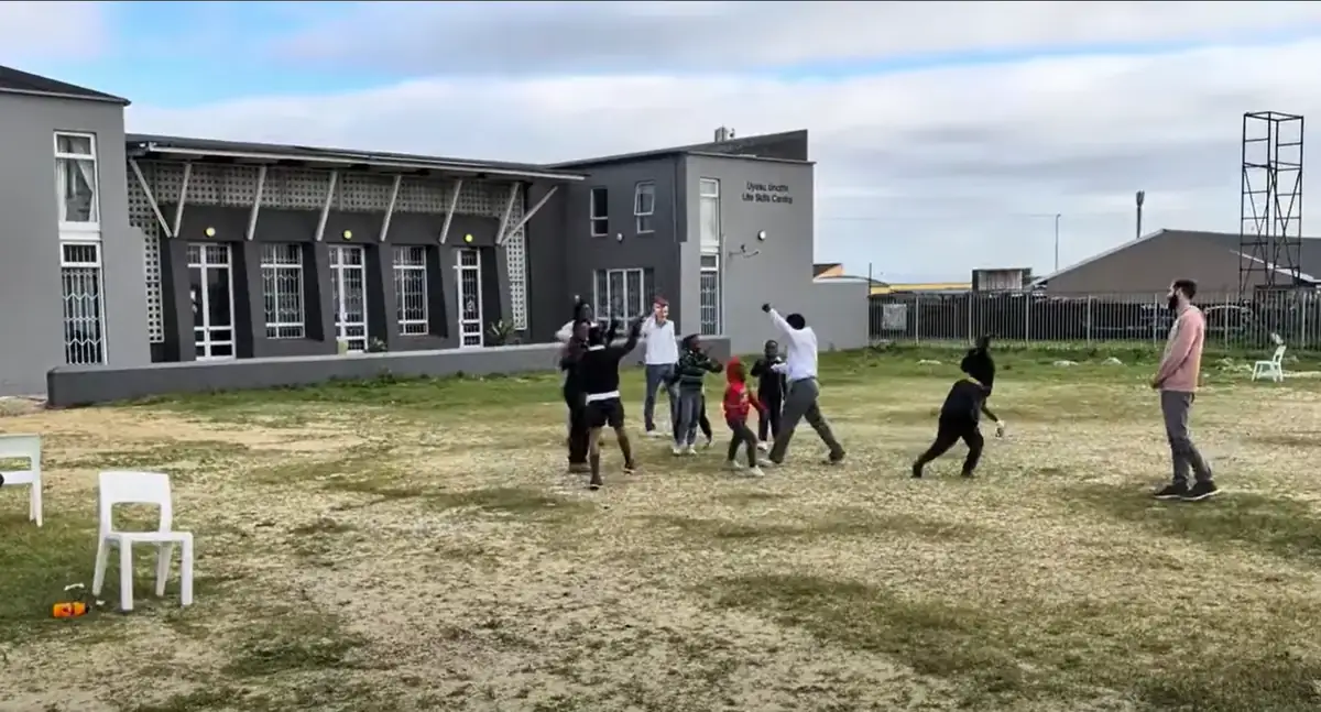 Learners playing on the field outside the Nguzo Saba campus